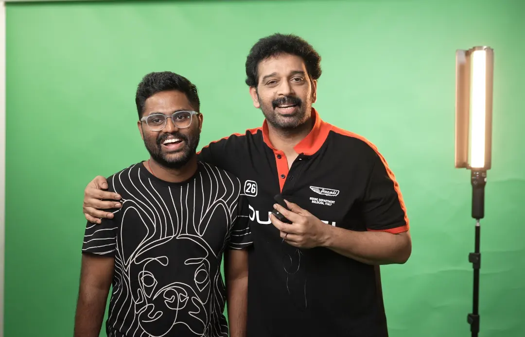 Vamshi with J. D. Chakravarthy in front of a studio green screen